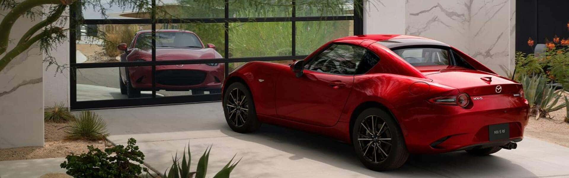 2024 Mazda MX-5, Parked in A Driveway With a Reflective Garage Door In Front Of It