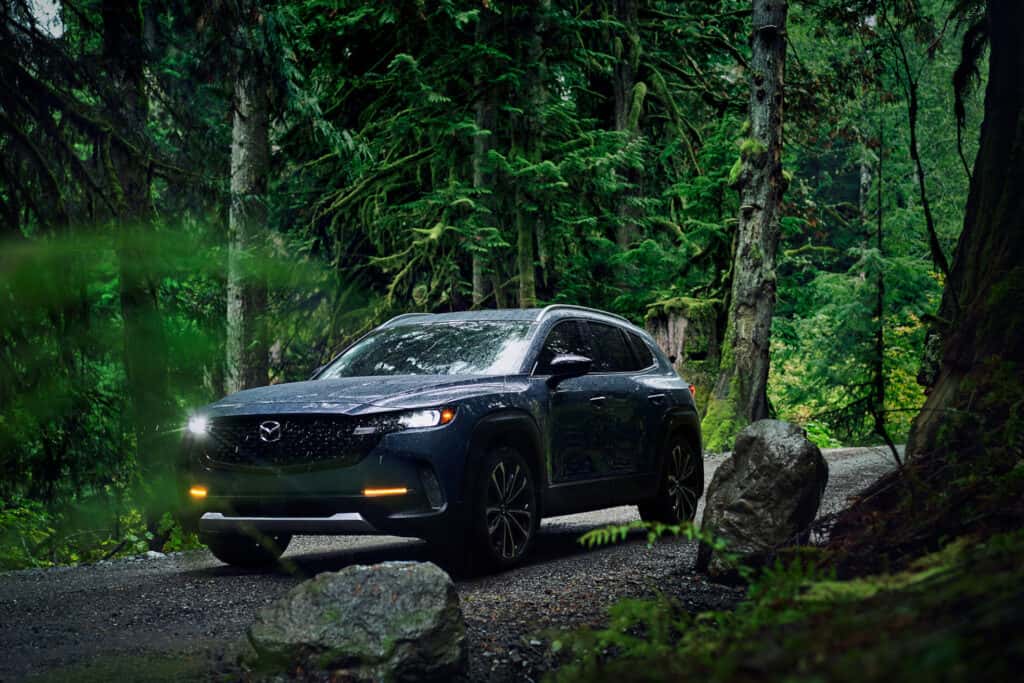 A Mazda CX-50 in the forest, one model available with Mazda lease deals