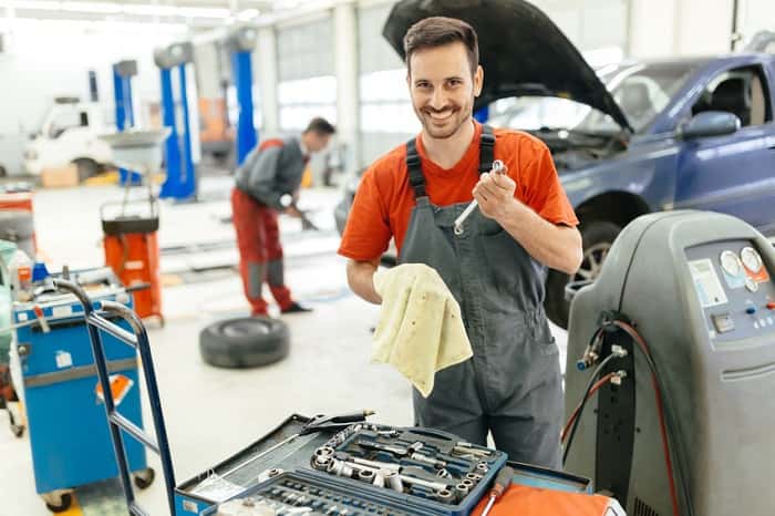 Mazda auto repair technician working on a car