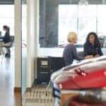 Customers discussing a Mazda lease with a dealer