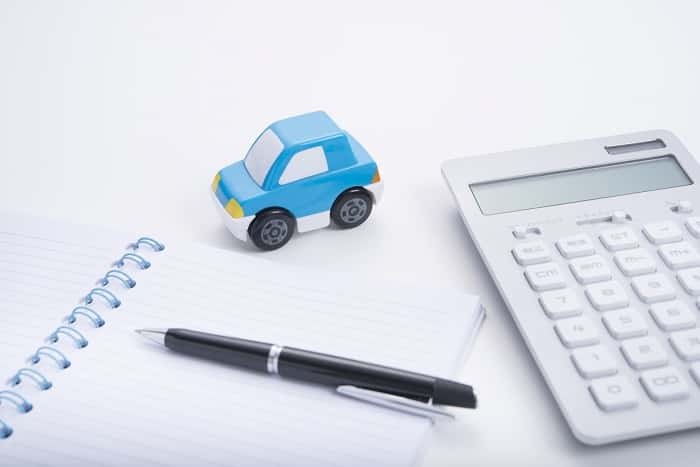 Calculating Mazda financing budget with a notepad