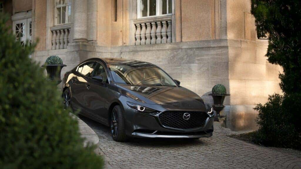 The 2026 Mazda3 Sedan driving in the city