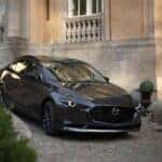 The 2026 Mazda3 Sedan driving in the city