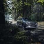 A Mazda CX-9 driving through a forest
