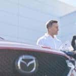 Woman speaking with a salesperson about Mazda warranty coverage
