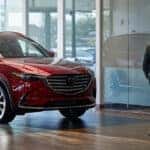 Customer walking through the showroom at a Mazda dealership