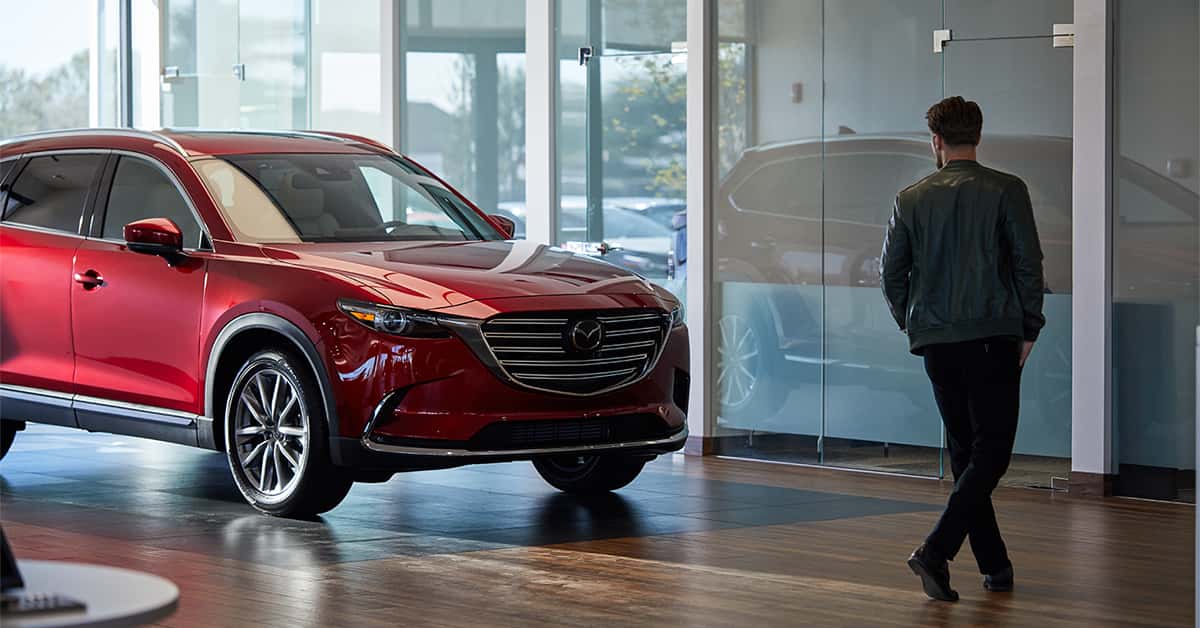 Customer walking through the showroom at a Mazda dealership