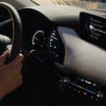 A driver behind the wheel of the Mazda3 Sedan
