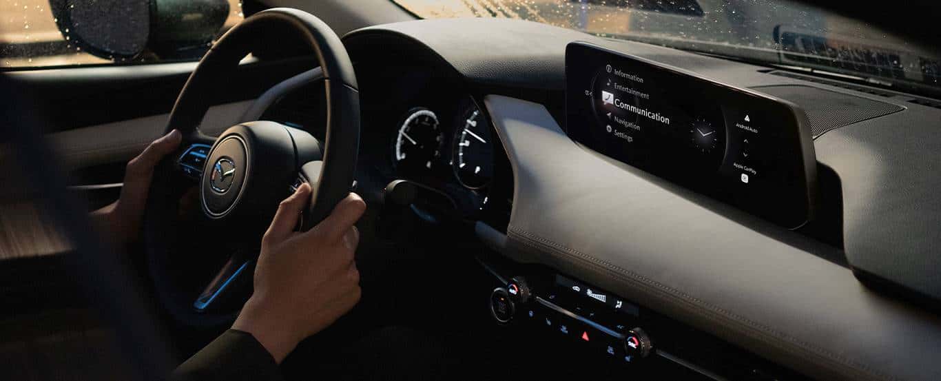 A driver behind the wheel of the Mazda3 Sedan