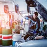 Technician changing oil during a Mazda service appointment