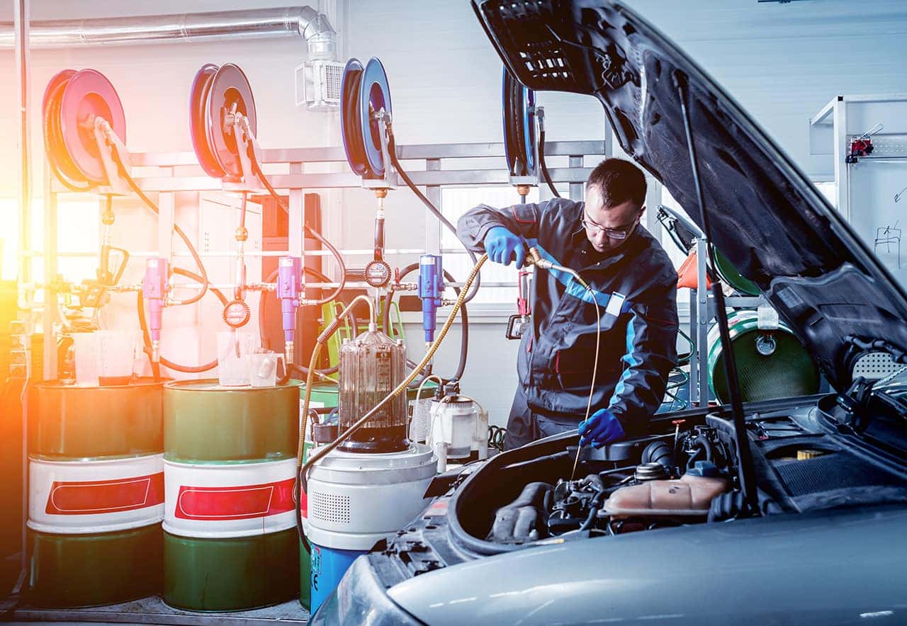 Technician changing oil during a Mazda service appointment