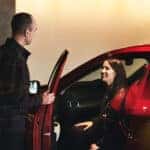 Customer sitting in a car in a Mazda showroom