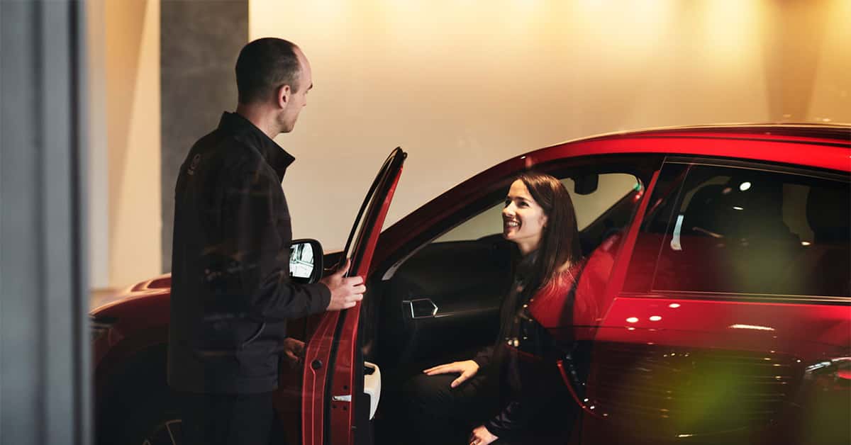 Customer sitting in a car in a Mazda showroom